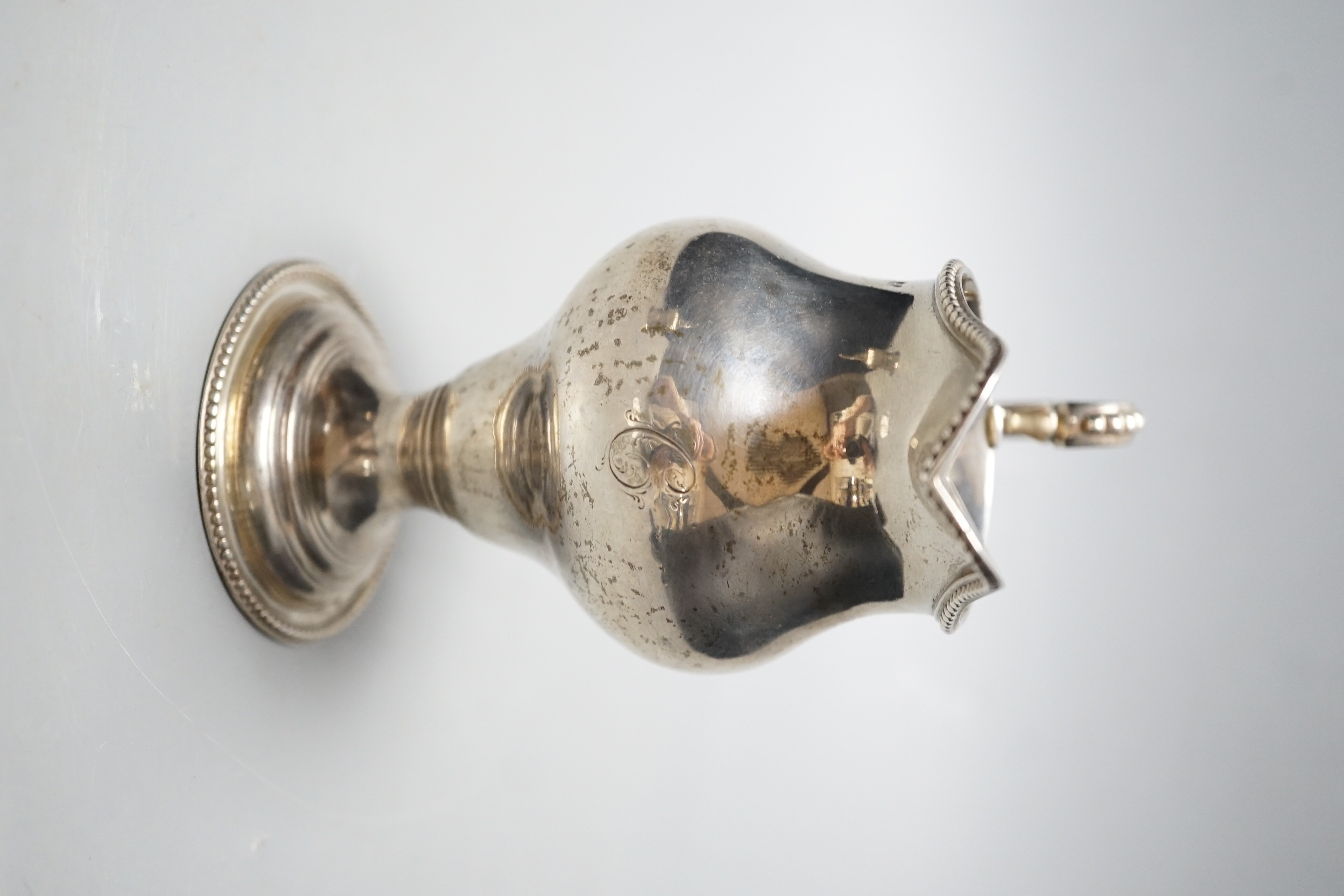 A George III silver inverted pear shaped cream jug, London, 1779, 31.1cm, maker's mark rubbed.